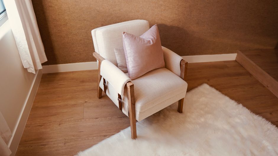 A comfortable armchair with a soft cushion, perfect for a modern living room setting.